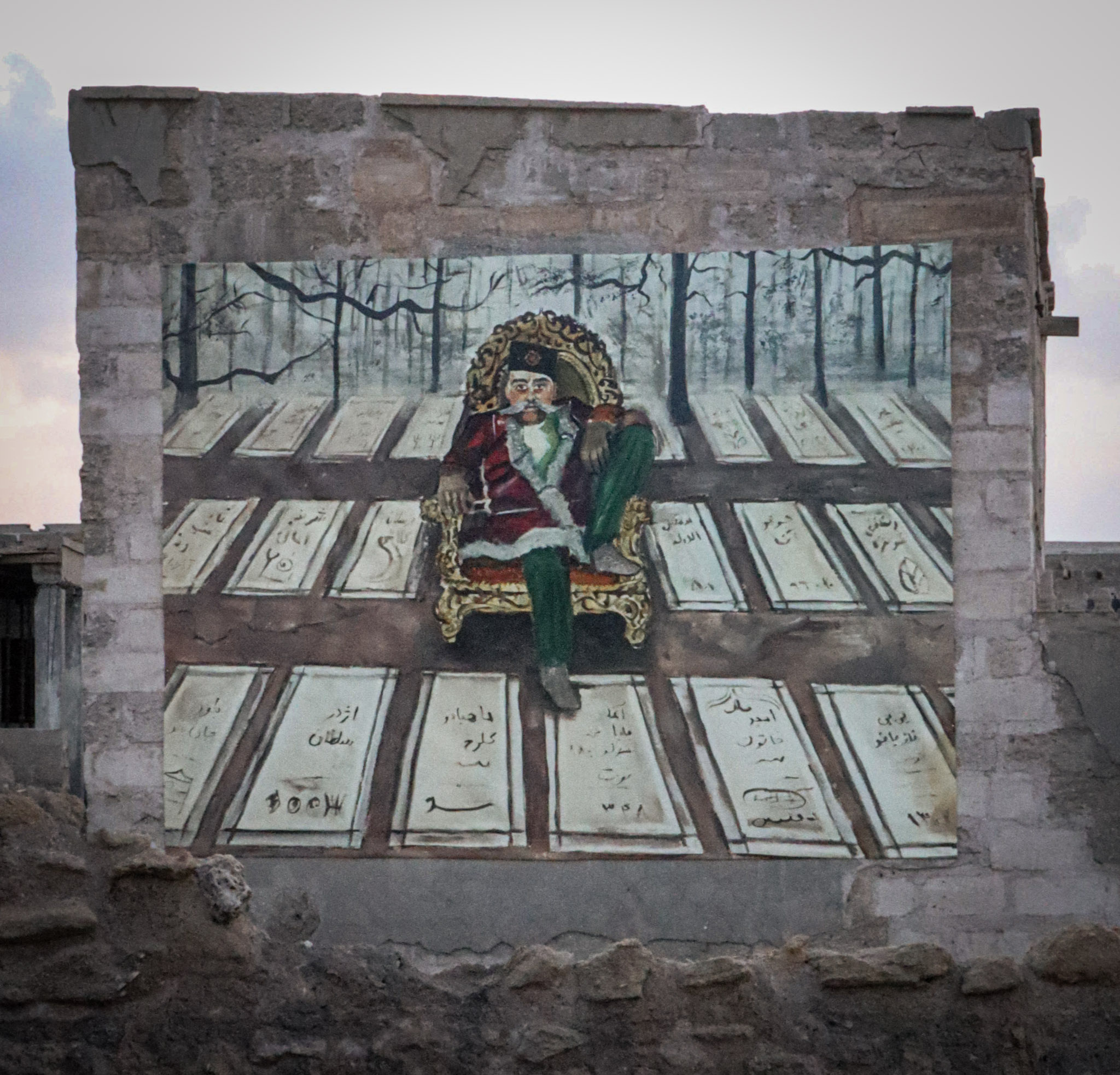 Painting of a man sitting on a throne above rows of graves displayed indoors.